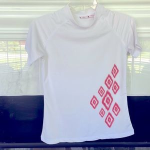 White women’s XS swim shirt with Coral diamond accents. Slight faint flaw.